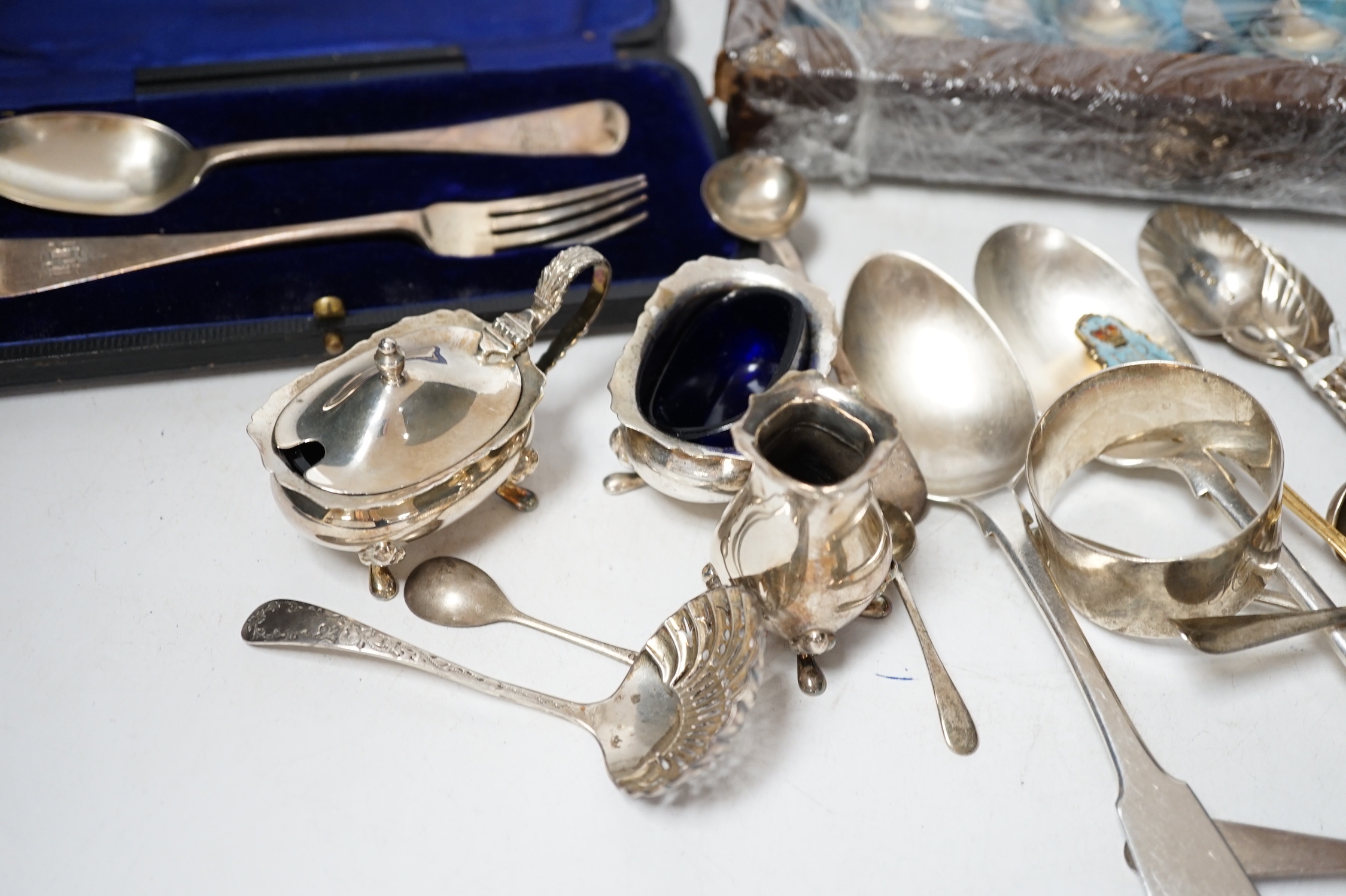 A group of assorted mainly small silver flatware, including 19th century, a small group of sterling spoons, a silver napkin ring and cased silver christening spoon and fork, etc.